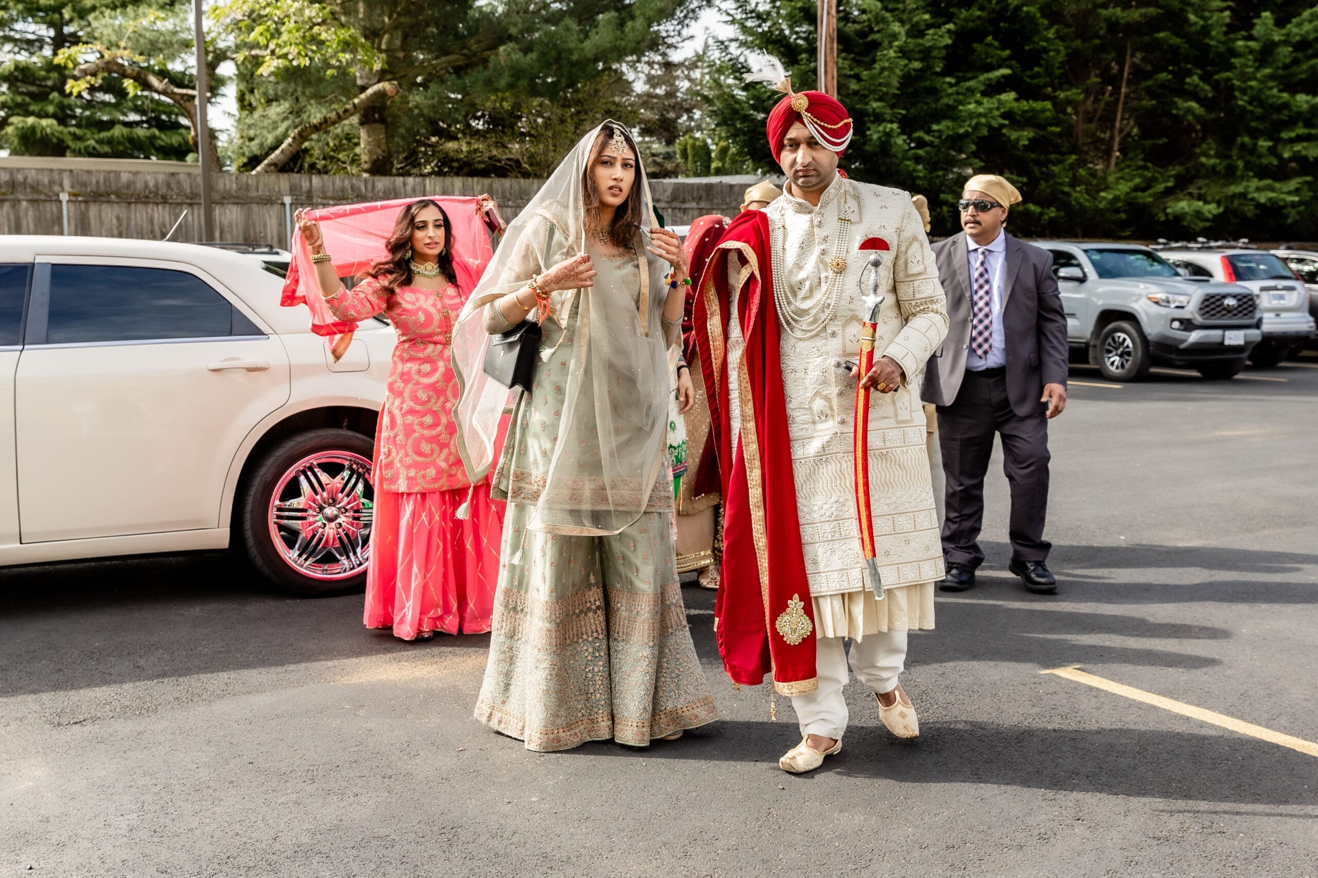 Luxury wedding limo arrival for a Punjabi wedding couple in traditional attire in Portland.